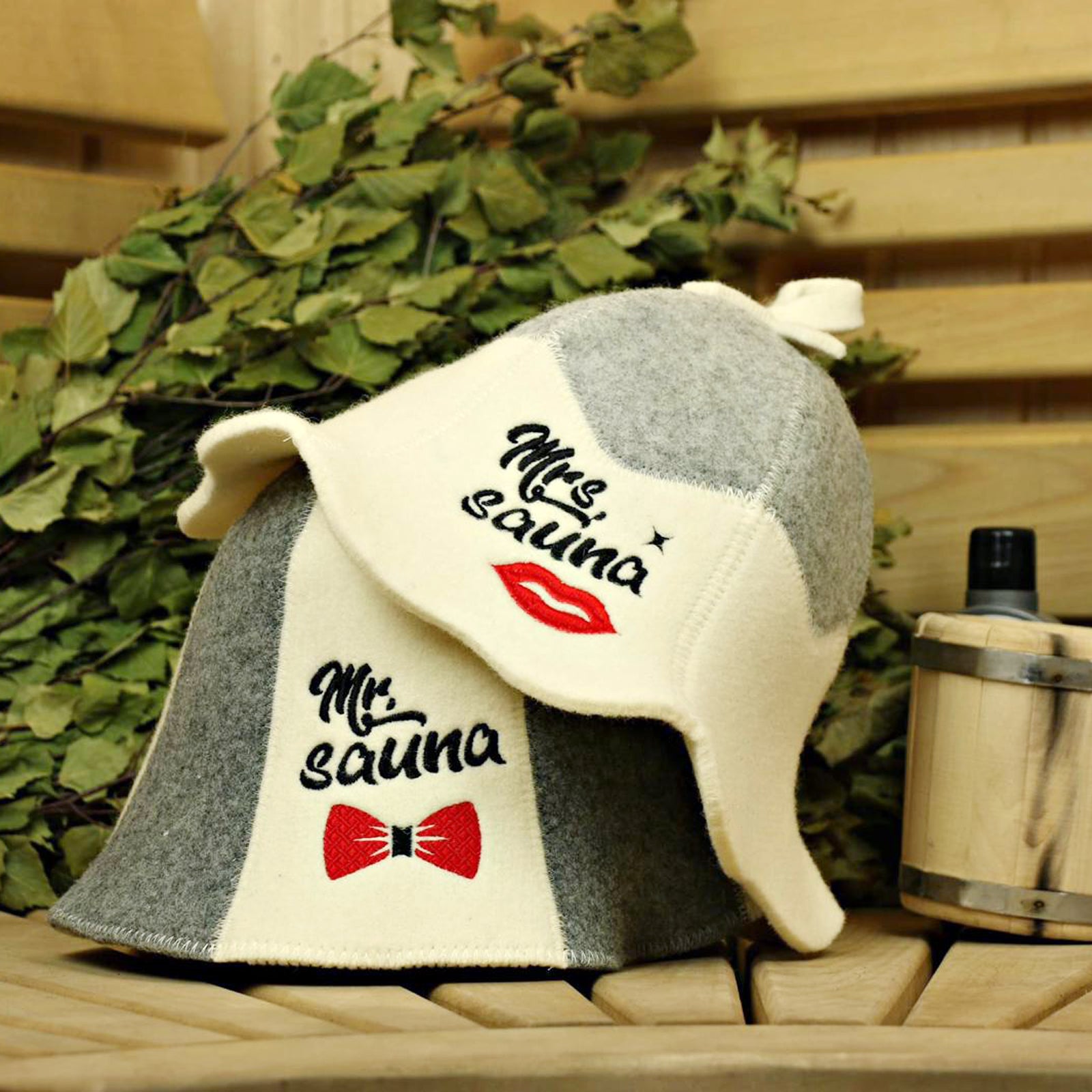 Single light grey and white wool sauna hat. The hat features the text 'Mr. Sauna' and a red bow tie graphic. It also has a loop at the top